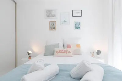a bedroom with a bed with towels on it at Comfortable 1 Bdr Downtown - AC & Parking in Nice