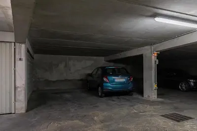 a small blue car parked in a parking garage at Comfortable 1 Bdr Downtown - AC & Parking in Nice