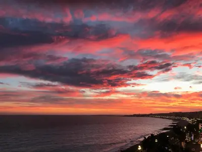 a sunset over the ocean with a cloudy sky at Sea view - Promenade des Anglais in Nice