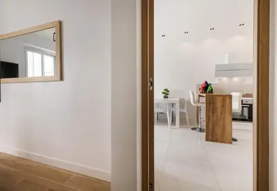 a room with a mirror and a dining room at Sea view - Promenade des Anglais in Nice