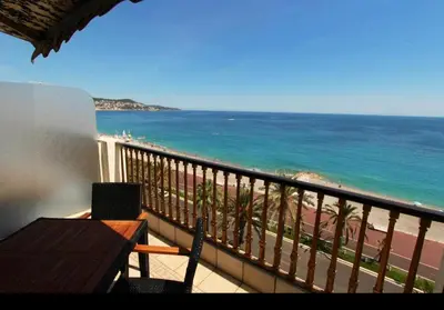 a balcony with a view of the beach and the ocean at Appartement Front de Mer - Promenade des Anglais in Nice