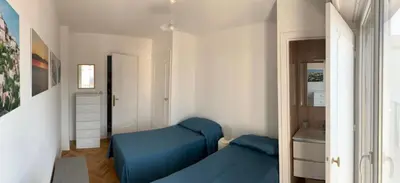a living room with a blue couch in a room at Appartement Front de Mer - Promenade des Anglais in Nice