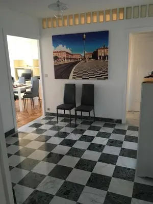 a room with two chairs and a checkered floor at Appartement Front de Mer - Promenade des Anglais in Nice