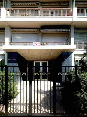 an apartment building with a balcony and a gate at Appartement Front de Mer - Promenade des Anglais in Nice