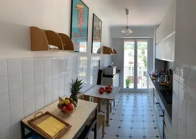a kitchen with a table with a bowl of fruit on it at Appartement Front de Mer - Promenade des Anglais in Nice