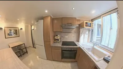 a small kitchen with a sink and a refrigerator at Cosy Duplex au Port du Vieux Nice in Nice