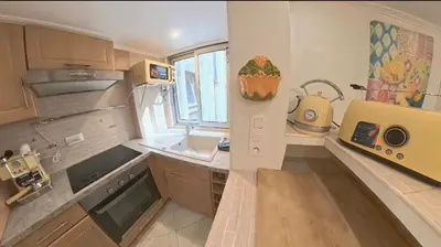 a small kitchen with a sink and a microwave at Cosy Duplex au Port du Vieux Nice in Nice