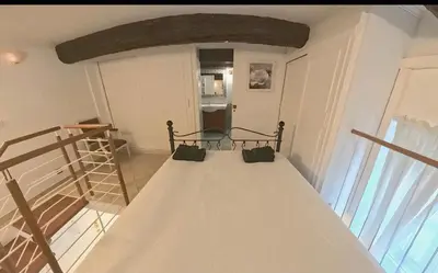 a room with a bed in a room with a window at Cosy Duplex au Port du Vieux Nice in Nice
