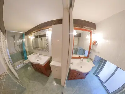 a bathroom with two sinks and a mirror at Cosy Duplex au Port du Vieux Nice in Nice