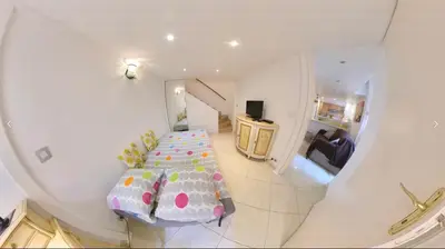 a bedroom with a bed and a living room at Cosy Duplex au Port du Vieux Nice in Nice