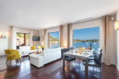 a living room with a white couch and a table at MY CASA - MARINIÈRES - Incredible view over the Bay in Villefranche-sur-Mer