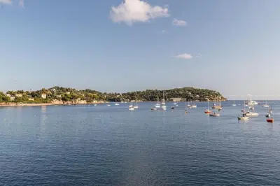 a group of boats floating on a large body of water at MY CASA - MARINIÈRES - Incredible view over the Bay in Villefranche-sur-Mer