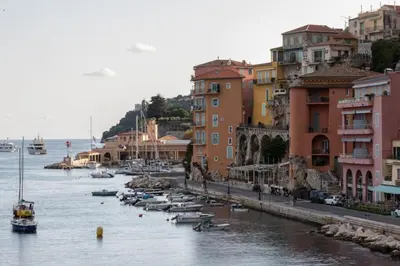 a group of boats in the water next to buildings at MY CASA - MARINIÈRES - Incredible view over the Bay in Villefranche-sur-Mer