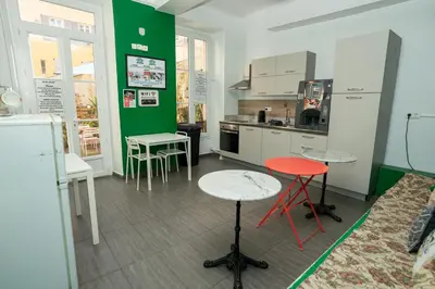 a kitchen with two tables and two stools at Le Pastoral in Nice