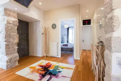 a living room with a stone fireplace and a rug at MY CASA - GIOFFREDO 14 - Spacious apartment with balcony in Nice