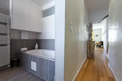 a bathroom with a bath tub in a room at MY CASA - GIOFFREDO 14 - Spacious apartment with balcony in Nice