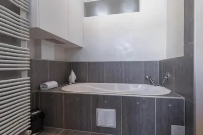 a bathroom with a large tub in a room at MY CASA - GIOFFREDO 14 - Spacious apartment with balcony in Nice
