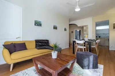 a living room with a yellow couch and a table at MY CASA - GIOFFREDO 14 - Spacious apartment with balcony in Nice