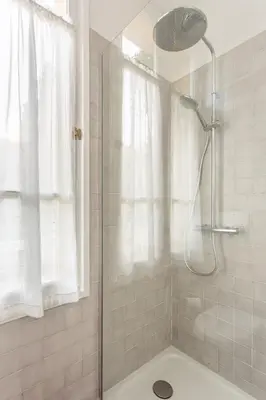 a shower with a glass door in a bathroom at Seaside Studio by iCasamia it in Nice
