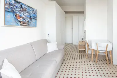 a living room with a couch and a table at Seaside Studio by iCasamia it in Nice