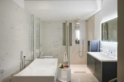 a white bathroom with a tub and a sink at Sunlight Properties - Sky blue - 3 bedroom flat with sea view on the Promenade des Anglais in Nice