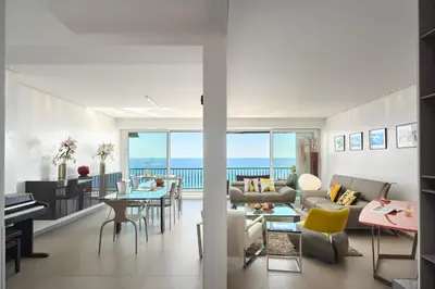 a living room with a view of the ocean at Sunlight Properties - Sky blue - 3 bedroom flat with sea view on the Promenade des Anglais in Nice