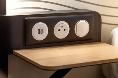 a counter with a alarm clock on top of a table at B&B HOTEL Nice Aéroport Arenas in Nice