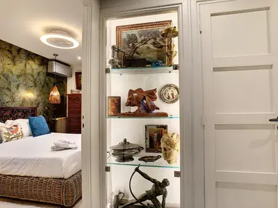a bedroom with a bed and a book shelf at Nestor&Jeeves - LOU FRANCESCAN - Old Town - Close sea - Place St Francois in Nice