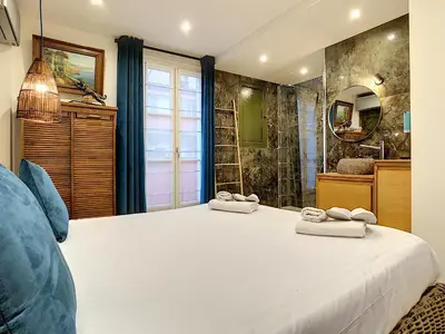 a bedroom with a large white bed and a bathroom at Nestor&Jeeves - LOU FRANCESCAN - Old Town - Close sea - Place St Francois in Nice