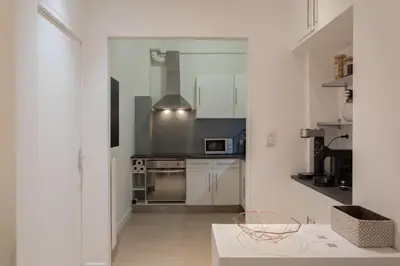 a kitchen with white cabinets and a stove at 26 nice , La Riviera in Nice