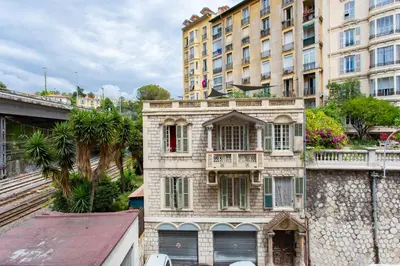 an old building with a balcony in front of a building at 26 nice , La Riviera in Nice