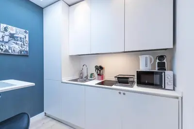 a kitchen with white cabinets and a microwave at Magenta Square Central 1 Bdr with AC in Nice