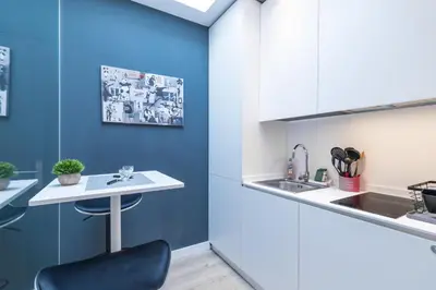 a kitchen with a white counter and a black chair at Magenta Square Central 1 Bdr with AC in Nice