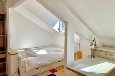 a white bedroom with a bed in a attic at Studio on the Attic 3min from the Sea & Main street in Nice