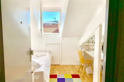 a room with a bed and a desk and a window at Studio on the Attic 3min from the Sea & Main street in Nice