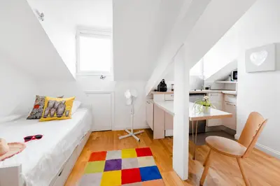 a white room with a bed and a desk and a chair at Studio on the Attic 3min from the Sea & Main street in Nice