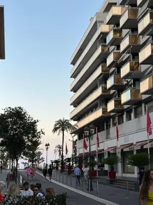 a large building with people standing in front of it at Petit 2 pièces Carré d'Or in Nice
