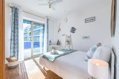 a bedroom with a bed and a large window at MY CASA - FRANCK PILATTE - Beautiful Sea View - Near the Port in Nice