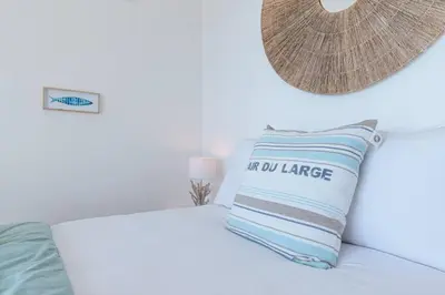 a room with a bed with a pillow and a lamp at MY CASA - FRANCK PILATTE - Beautiful Sea View - Near the Port in Nice