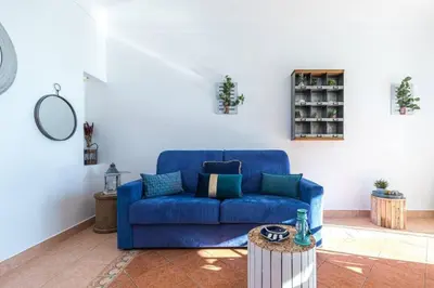 a blue couch sitting in a living room at MY CASA - FRANCK PILATTE - Beautiful Sea View - Near the Port in Nice