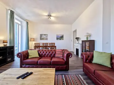 a living room with two leather couches and a table at Congrès Carré d'Or by Booking Guys in Nice