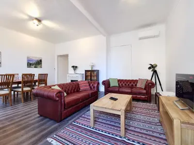 a living room with two couches and a table at Congrès Carré d'Or by Booking Guys in Nice