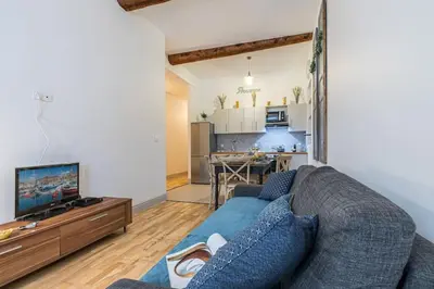 a living room with a blue couch and a kitchen at MY CASA - GALLIENI - Superb & Unique in City Center in Nice