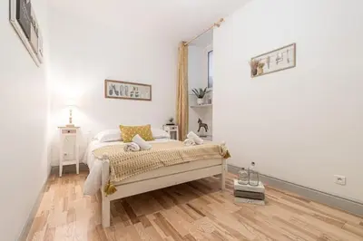 a white bedroom with a bed and a wooden floor at MY CASA - GALLIENI - Superb & Unique in City Center in Nice