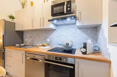 a kitchen with white cabinets and a stove top oven at MY CASA - GALLIENI - Superb & Unique in City Center in Nice