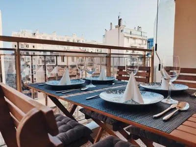 a table with wine glasses and napkins on a balcony at Legion Suite - Your perfect vacation ! in Nice