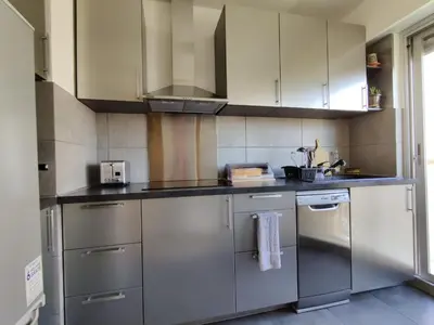 a kitchen with stainless steel appliances and white cabinets at Legion Suite - Your perfect vacation ! in Nice