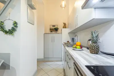 a kitchen with white cabinets and a counter top at MY CASA - SAINT SIAGRE 1 in Nice