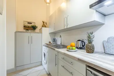 a kitchen with white cabinets and a dishwasher at MY CASA - SAINT SIAGRE 1 in Nice