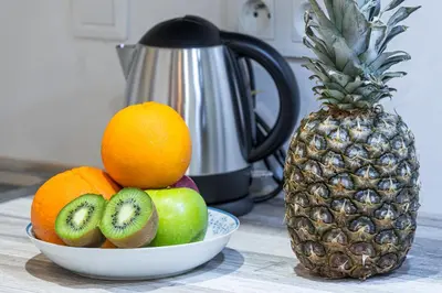 a bowl of fruit on a counter next to a pineapple at MY CASA - SAINT SIAGRE 1 in Nice